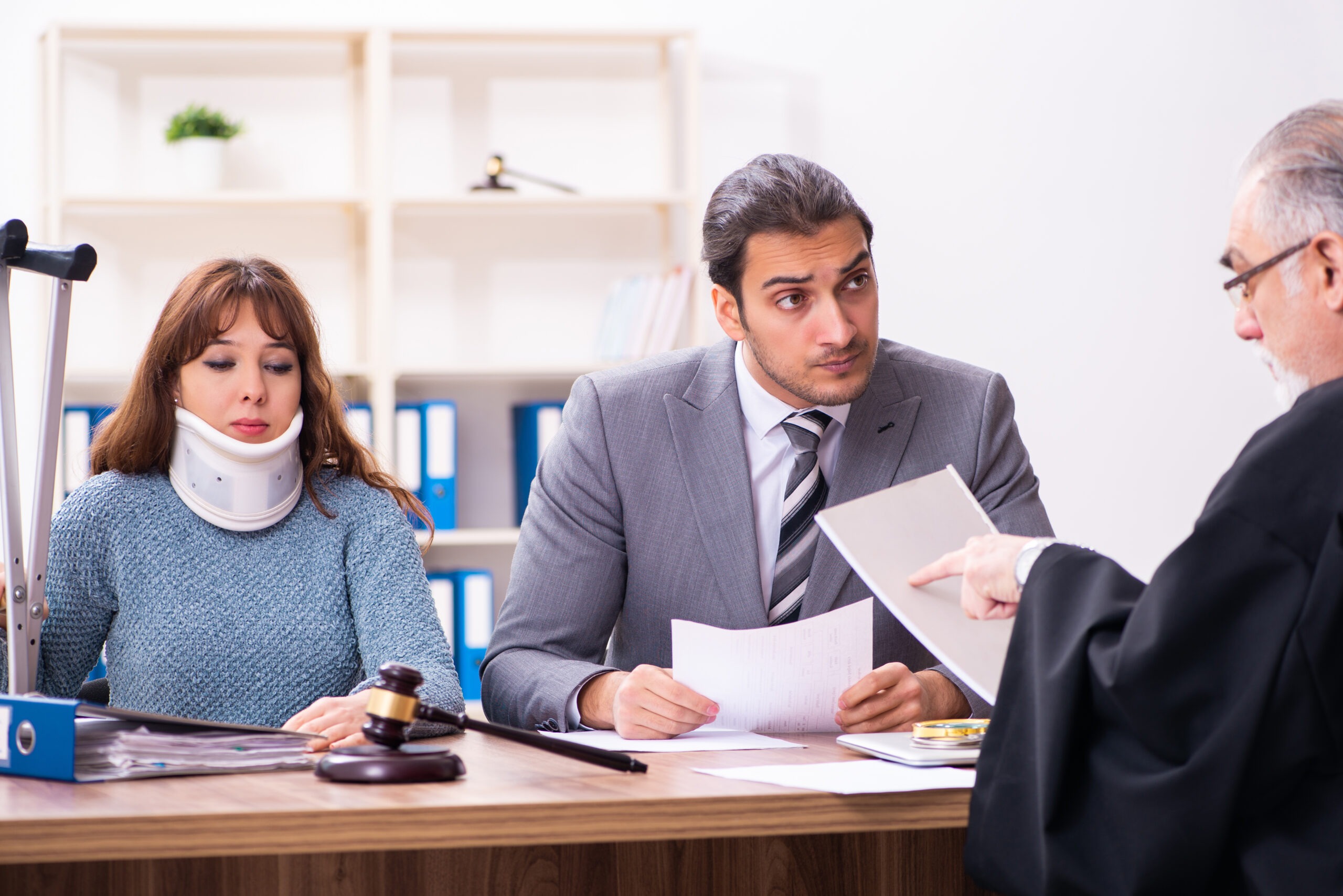 Young woman in courthouse with judge and lawyer
