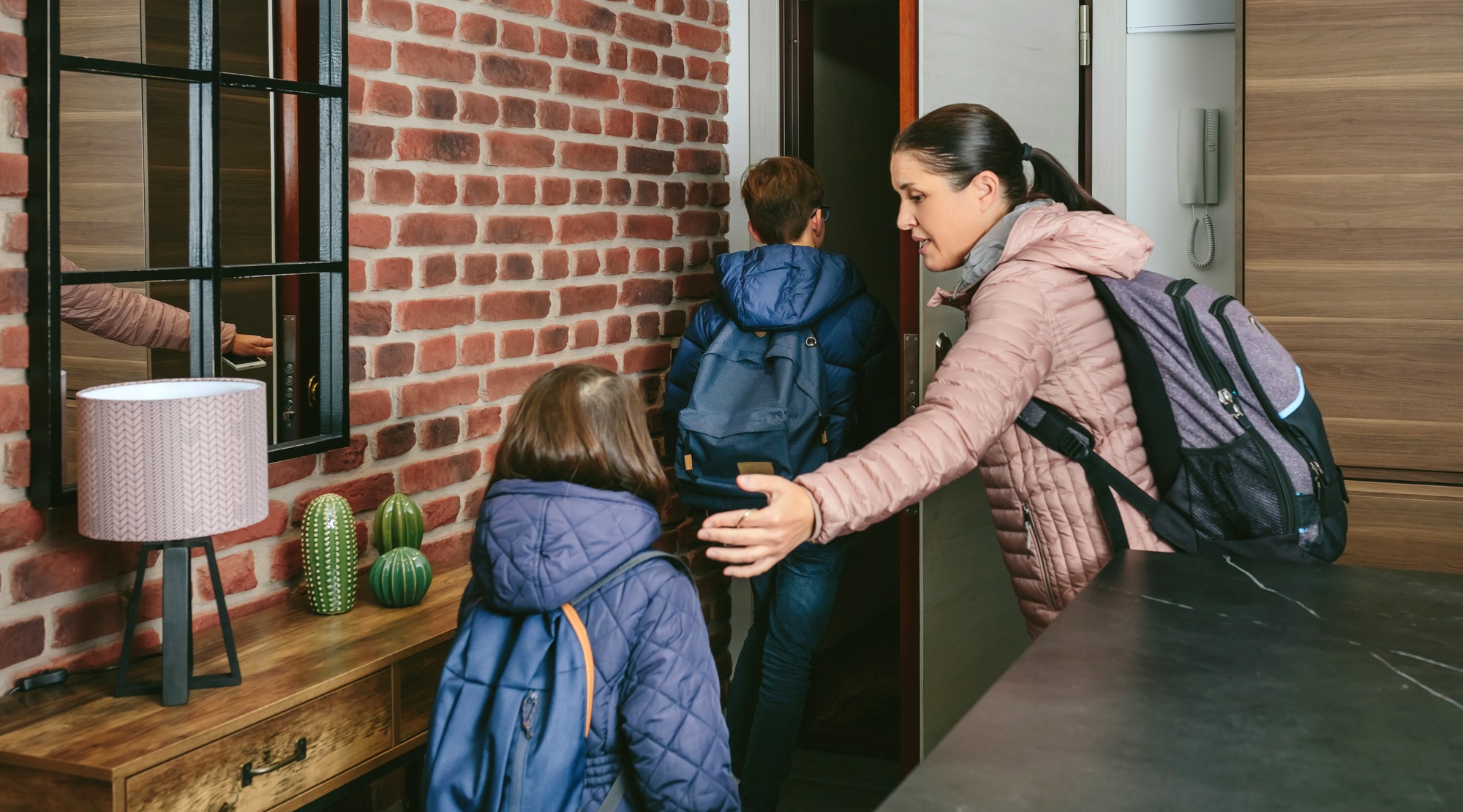 Family with emergency backpacks leaving their front door
